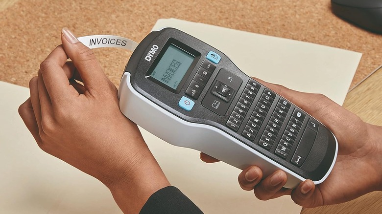 Person printing invoice label on Dymo Label Maker