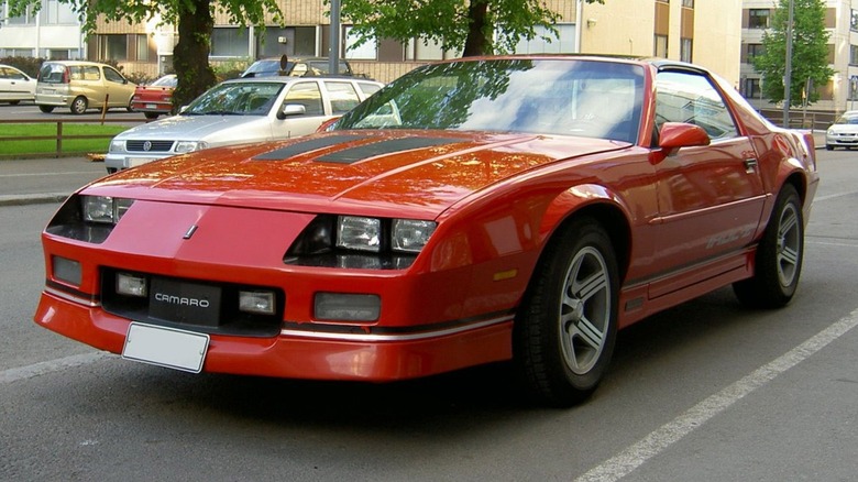 Red 1985 Chevrolet Camaro IROC-Z in a parking lot