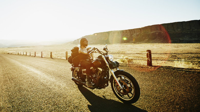 Woman riding motorcycle in the desert