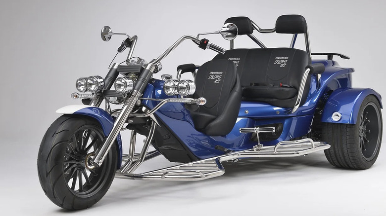 Blue Rewaco RF1 trike parked against gray background