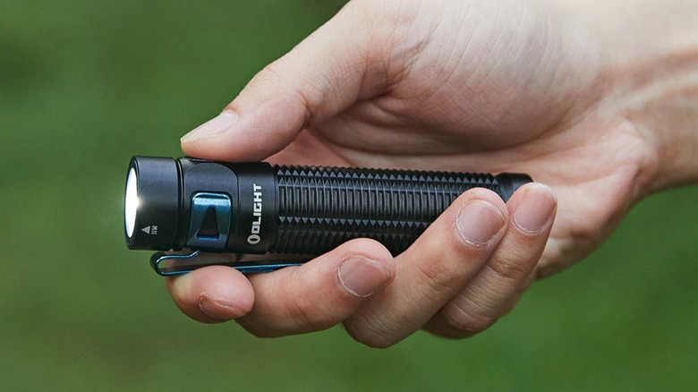 Olight flashlight in a person's hand