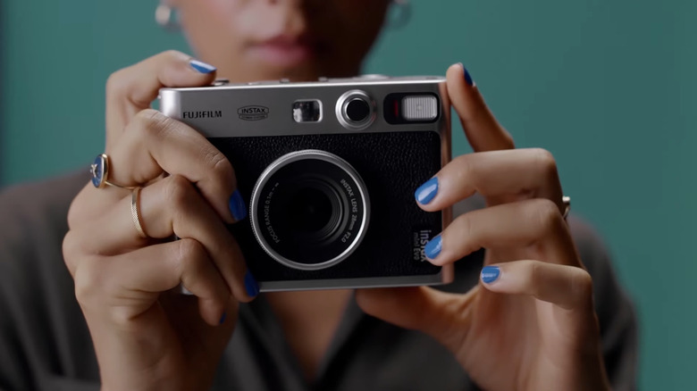 woman holding Fujifilm Instax Mini Evo