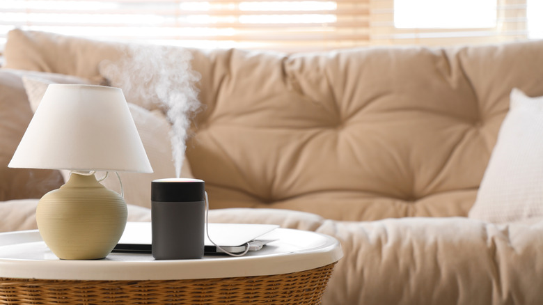 Humidifier on a table with a couch in the background