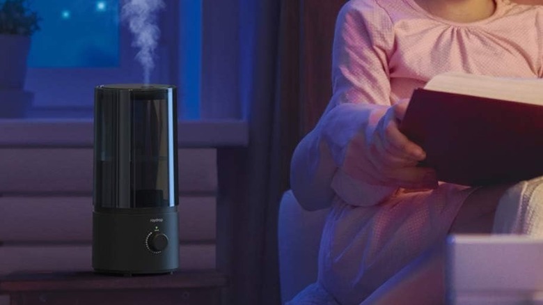 Child next to black humidifier