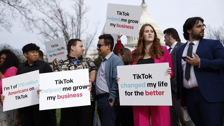 Protestors holding pro-TikTok signs