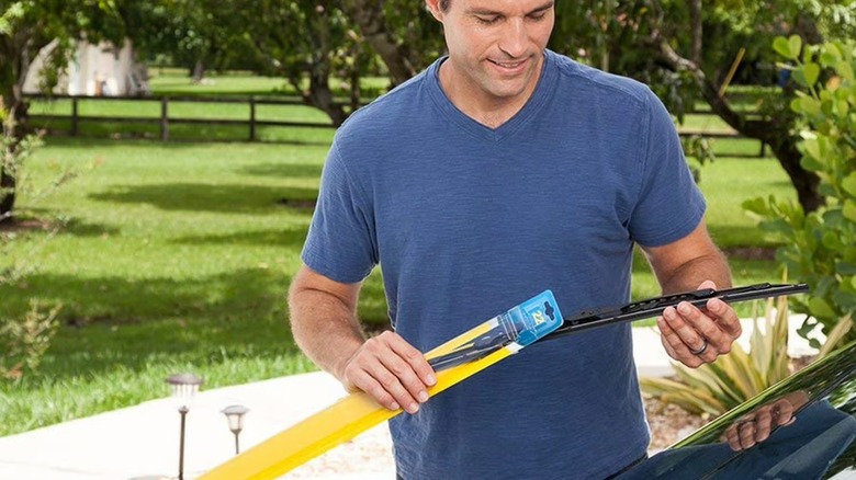 Person in their driveway installing Rain-X Weatherbeater Wiper Blade