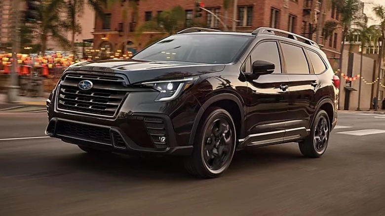 Crystal Black Silica Subaru Ascent Onyx Edition driving down city street with buildings in the background