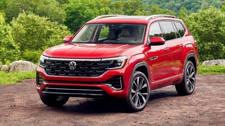 Volkswagen Atlas parked off-road with trees in the background