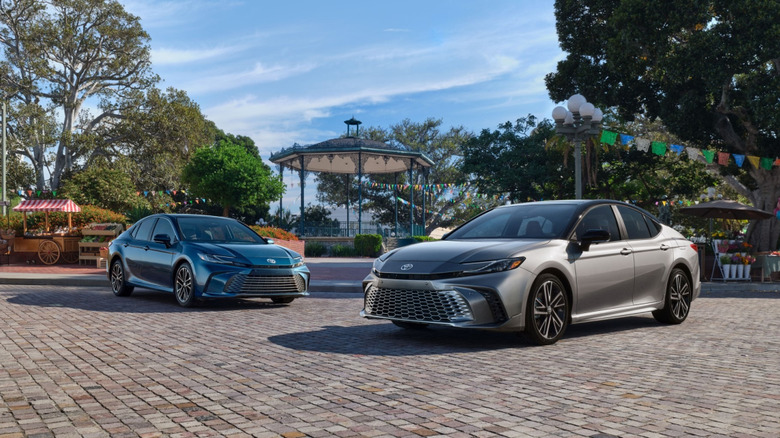 Two Toyota Camry hybrid sedans