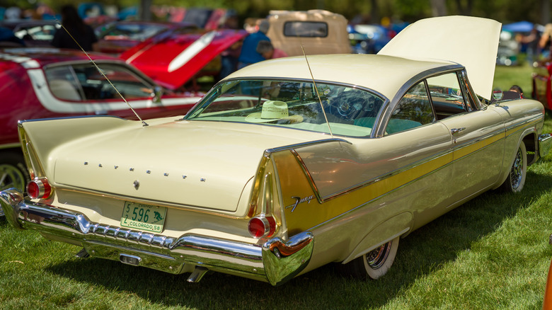 Yellow 1958 Plymouth Fury parked on grass