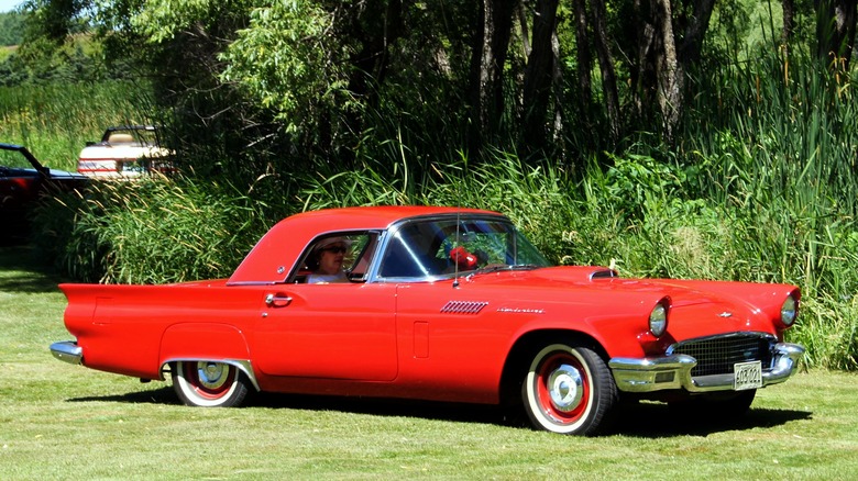 Red 1957 Ford Thunderbird on grass