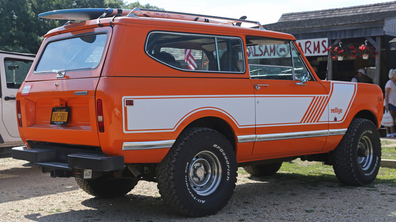 Orange and white International Scout Rallye parked outside Balsam Farms store