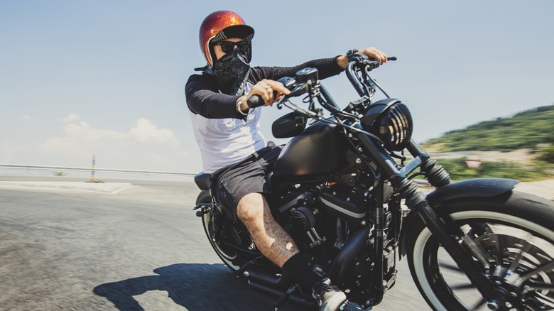 A man riding a cruiser motorcycle