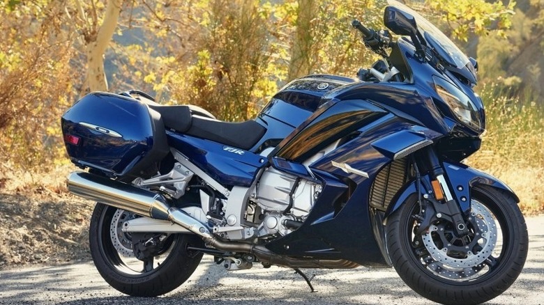 A Yamaha FJR1300ES aganst a background of trees.