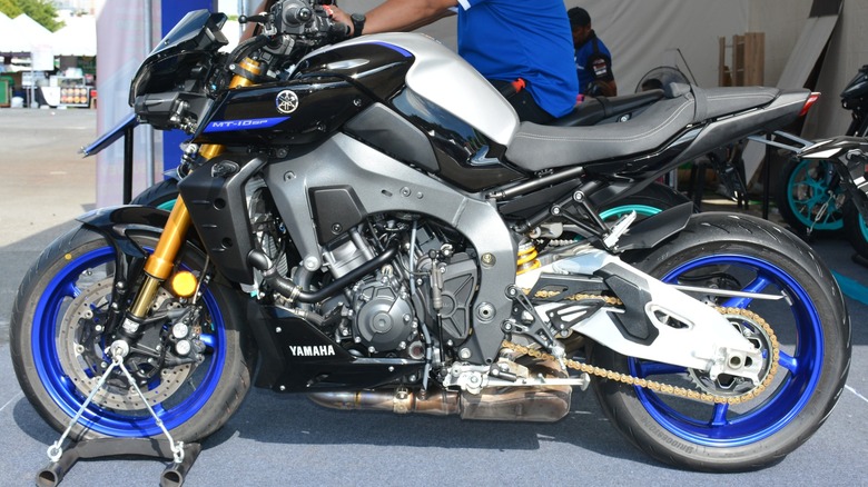 A gray, silver and black Yamaha MT-10 SP bike with blue trim.