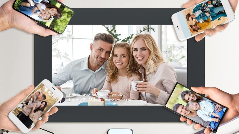 people with phones around a digital frame