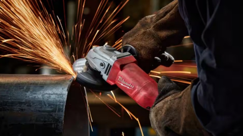 Milwaukee angle grinder in use creating sparks