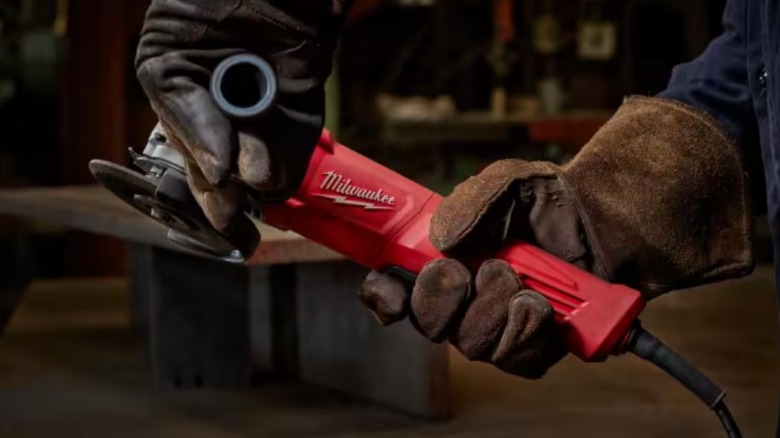 person holding milwaukee angle grinder