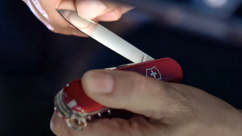 Person opening the blade of a Swiss Army Knife