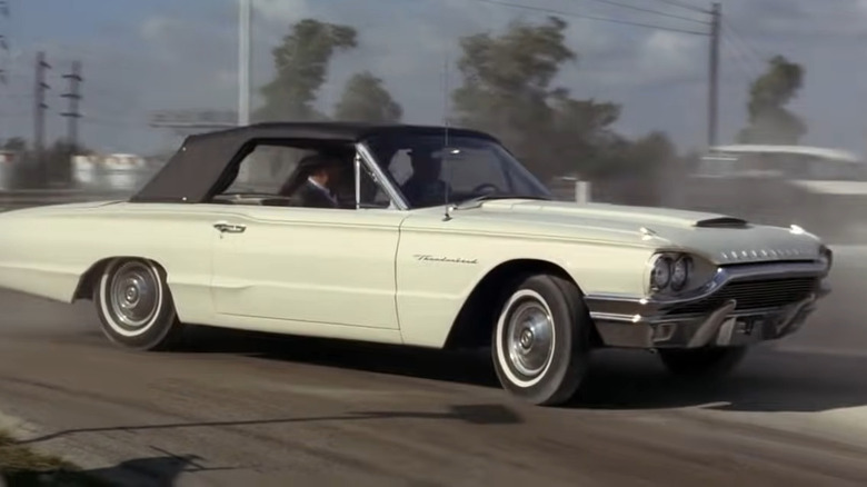 White Thunderbird driving quickly