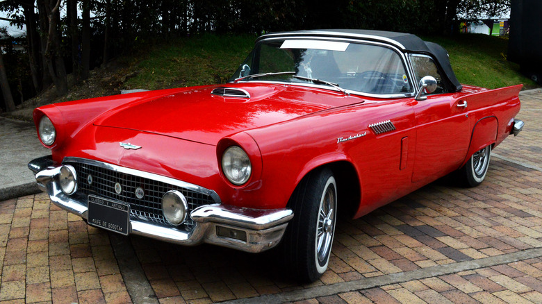 Red Thunderbird parked next to sidewalk