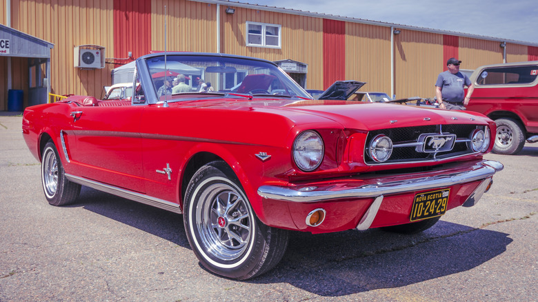 Red 1965 Ford Mustang parked front quarter view