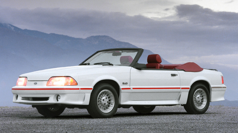 White 1987 Ford Mustang Foxbody convertible parked driver side view