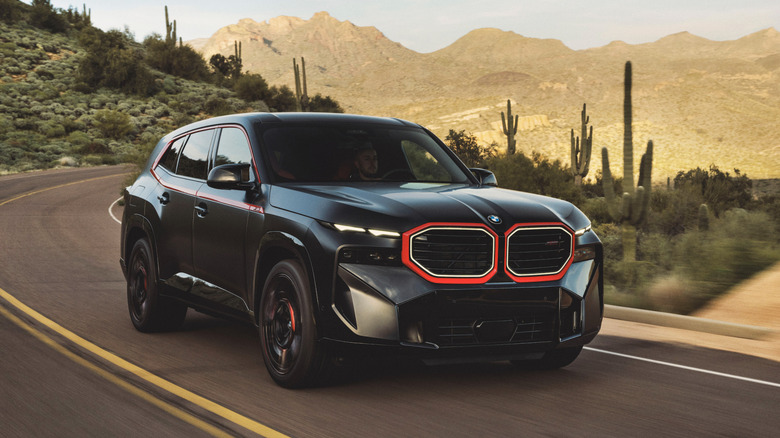 2025 BMW XM Label Red driving on desert road