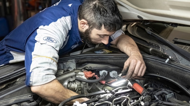 Ford mechanic working on a car