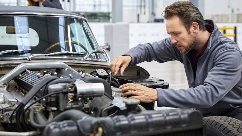 Man working on car engine