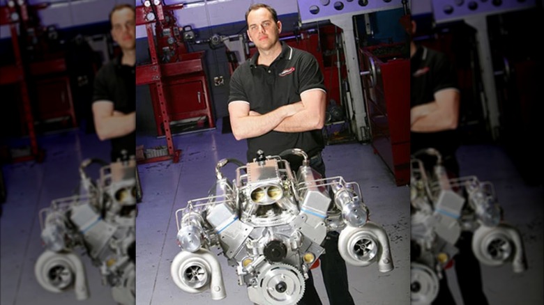 Tom Nelson posing with the F-Bomb Camaro engine.