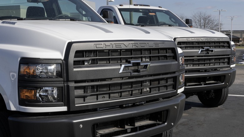 white Chevy Silverado 5500 medium-duty trucks on car lot