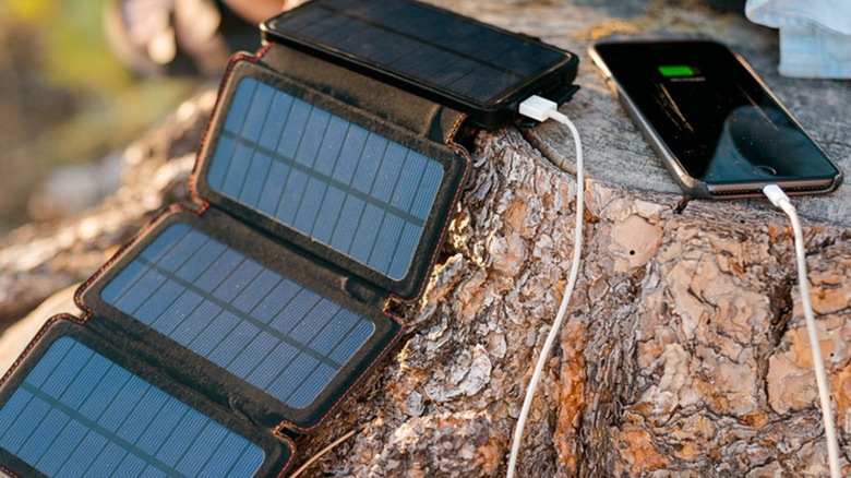 Survival Frog QuadraPro Solar Charger Power Bank charging a smartphone