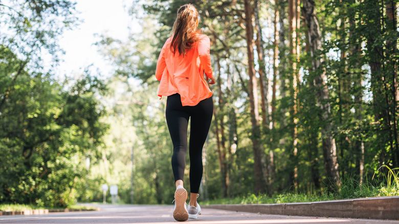 woman running on a park trail