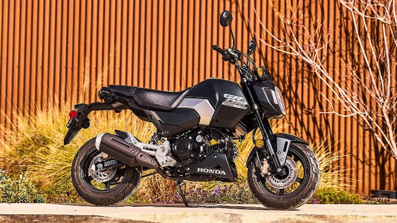 Honda Grom parked on sidewalk