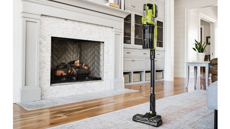 18V One+ HP Cordless Pet Stick Vacuum upright in a living room