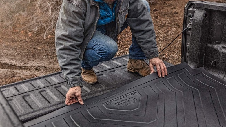 Man installing a Husky Liner mat