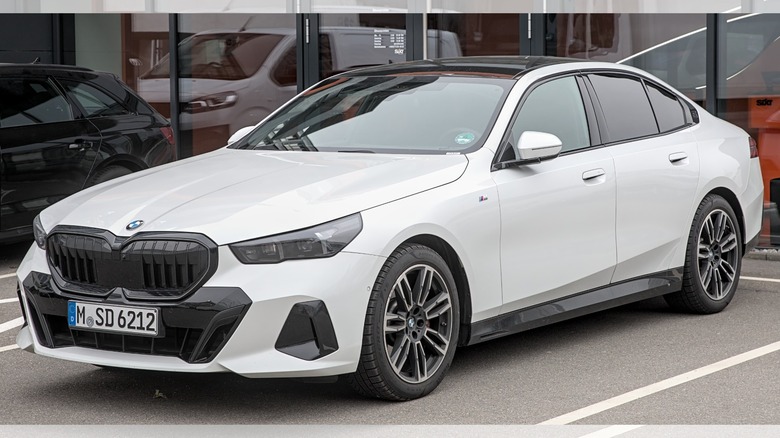 a white BMW 5 Series (G60) in the parking lot