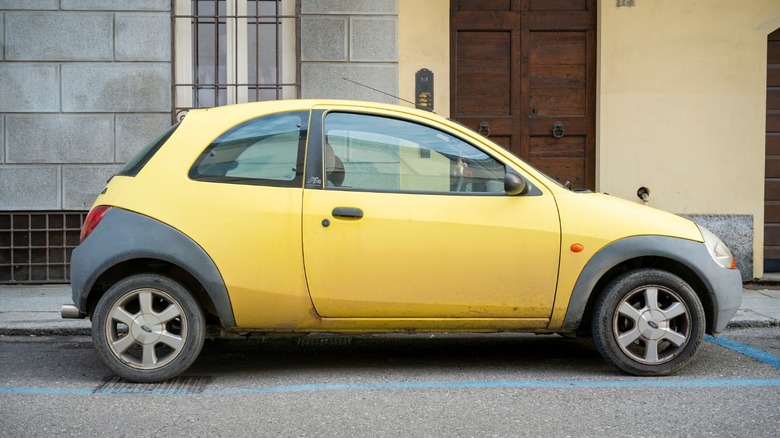 a yellow Ford Ka parked on the side of a street