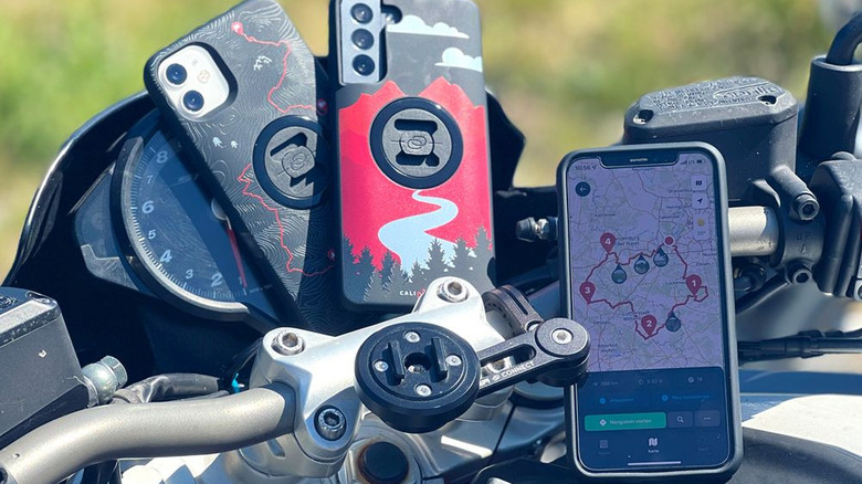 Phone on a motorcycle running the Calimoto app, with other phone also sitting on the bike