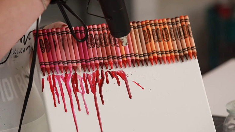 Heat gun melting a row of crayons.