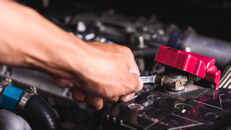 Mechanic fixing car battery