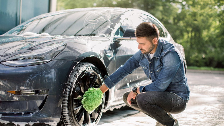 man cleaning car