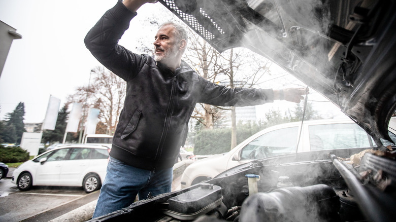 man with an overheated car