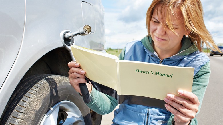Woman reading owner's manual