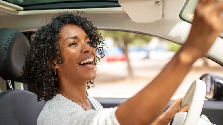 Woman smiling inside car