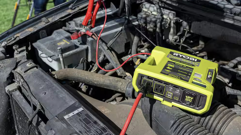 18V One+ 1000-watt Automotive Power Inverter in use while over car engine