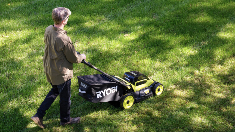 Person using a 18V One+ 20-inch Self-Propelled Mower