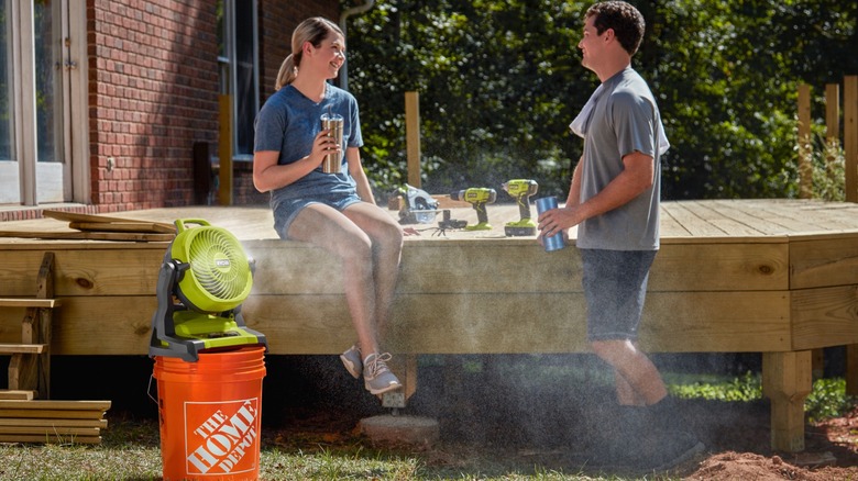 Couple using 18V One+ 7.5-inch Bucket Top Misting Fan