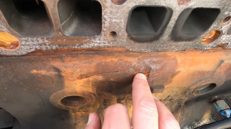 person showing cracked engine block